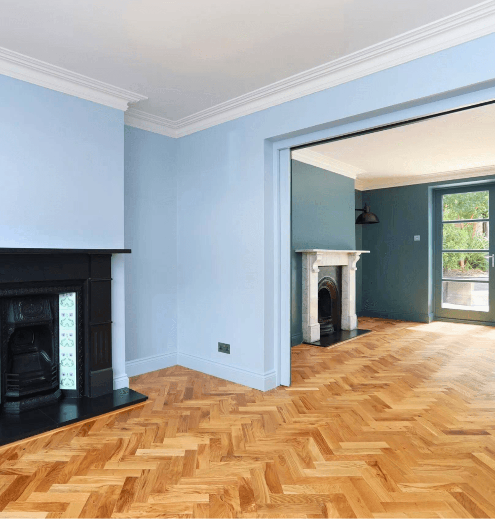 Georgian open-plan family and playroom with herringbone flooring and double pocket doors in Greenwich SE10, London