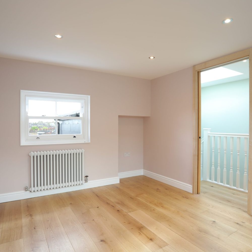Master bedroom in L-shaped dormer loft conversion in Greenwich SE10, London