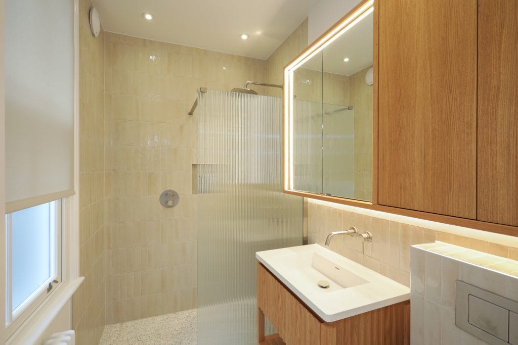 En-suite bathroom finished with Porcelanosa mosaic shower tray and modern fittings